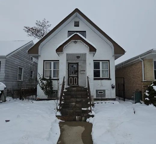 a front view of house with car parked