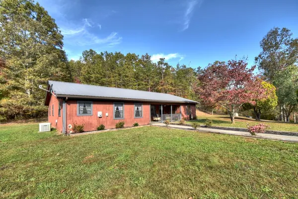 a front view of house with yard and trees