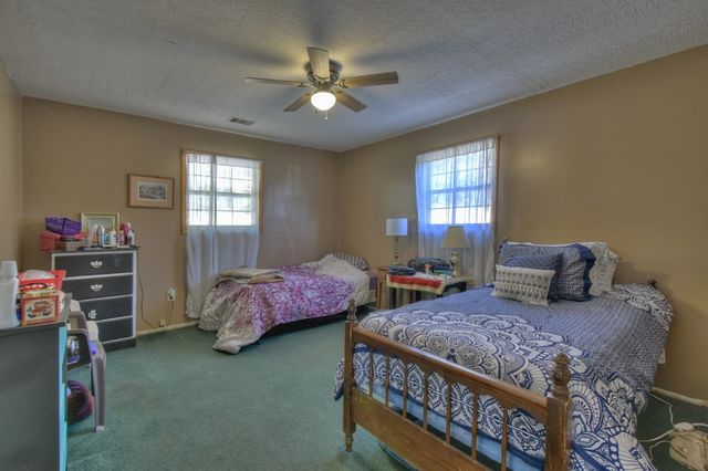 a bathroom with a sink a toilet a mirror and shower curtain