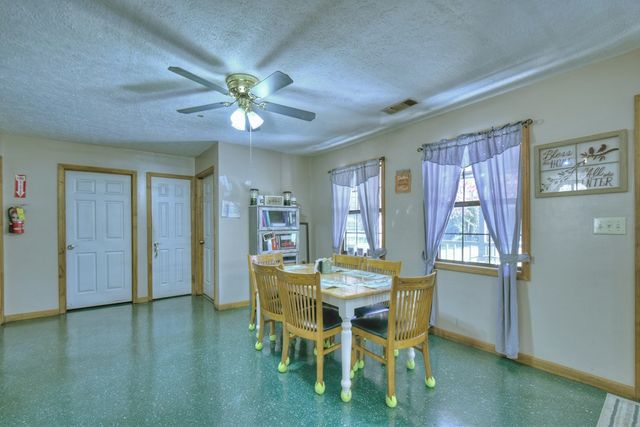 a view of a dining room with furniture and chandelier