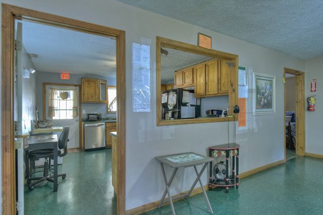a kitchen with stainless steel appliances granite countertop a stove a sink dishwasher and a refrigerator