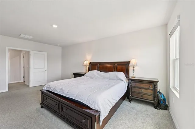 a bedroom with a bed and dresser