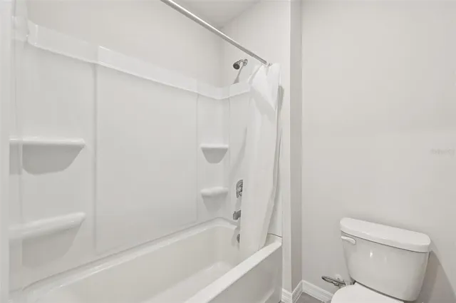 a bathroom with a bathtub and a toilet