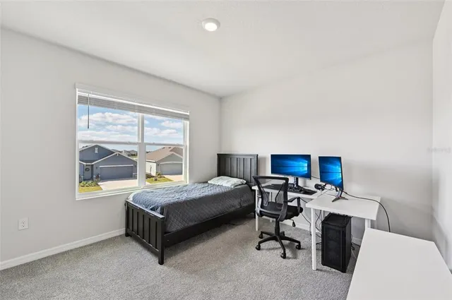 a bedroom with a bed and a table