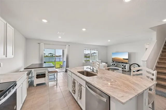 a kitchen with a sink a stove and cabinets