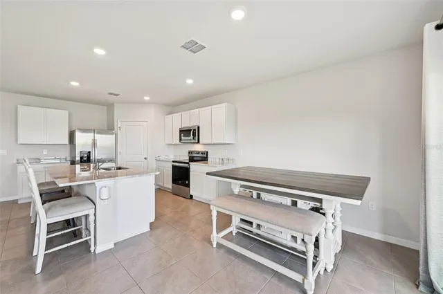 a kitchen with appliances a sink and cabinets