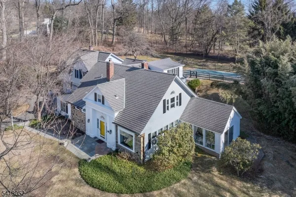 a aerial view of a house with a yard balcony and mountain view