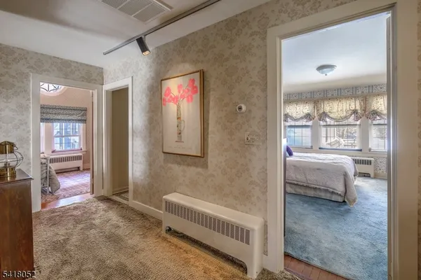 a bedroom with a bed chair and window