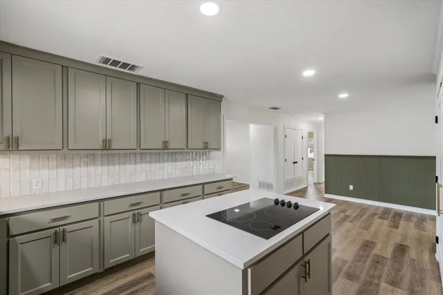 a kitchen that has a sink and a stove