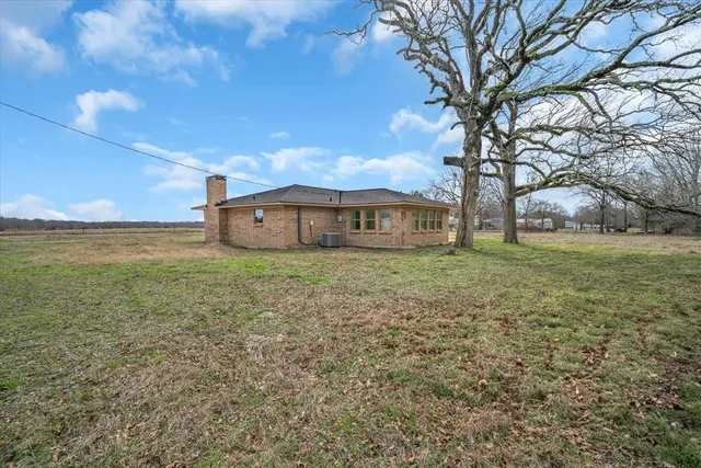 a house view with swimming pool in front of it