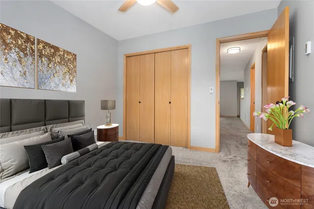 a bedroom with furniture and a flat screen tv