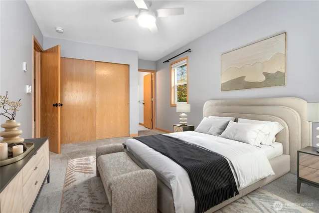 a bedroom with a large bed and a chandelier