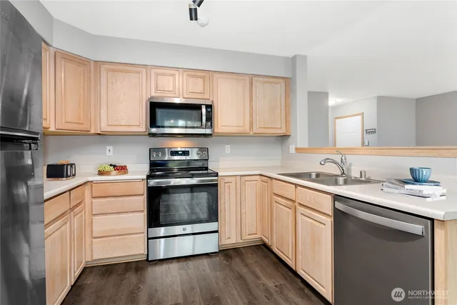 a kitchen with a sink stove and microwave