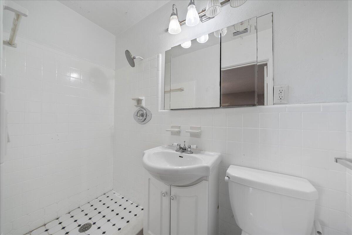 441 Sharon Drive Melbourne, FL 32935 - Photo 12 of 25 a bathroom with a sink a toilet and mirror