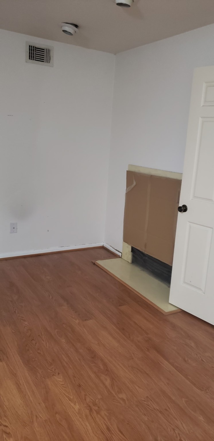 an empty room with wooden floor