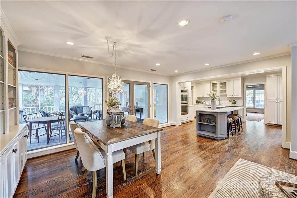3100 Clarendon Road Charlotte, NC 28211 - Photo 21 of 48 a view of a dining room and livingroom with furniture wooden floor a chandelier