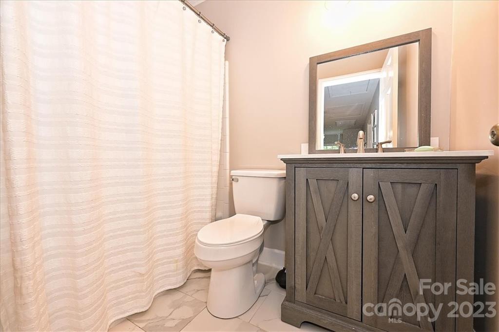 3100 Clarendon Road Charlotte, NC 28211 - Photo 33 of 48 a bathroom with a toilet a sink and mirror