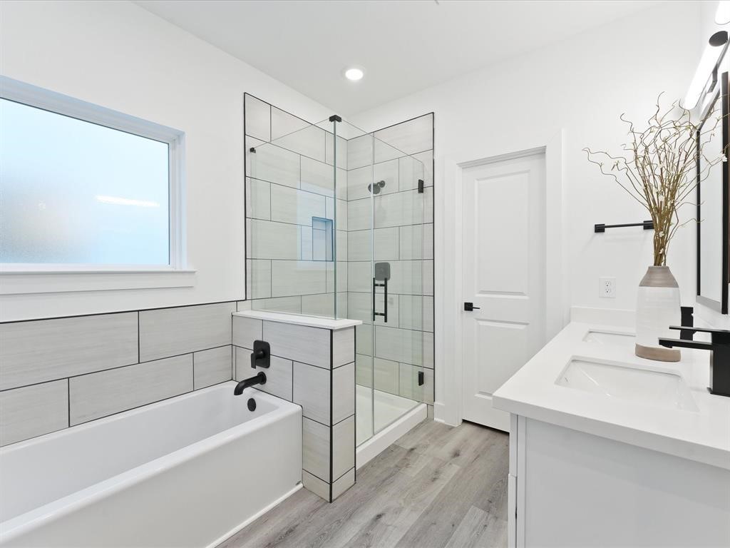 4012 Northfield Lane Houston, TX 77092 - Photo 11 of 17 a bathroom with a tub a sink and a large mirror