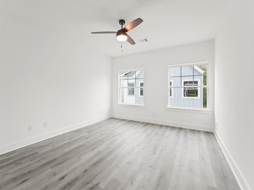 4012 Northfield Lane Houston, TX 77092 - Photo 13 of 17 a view of an empty room with wooden floor and a window