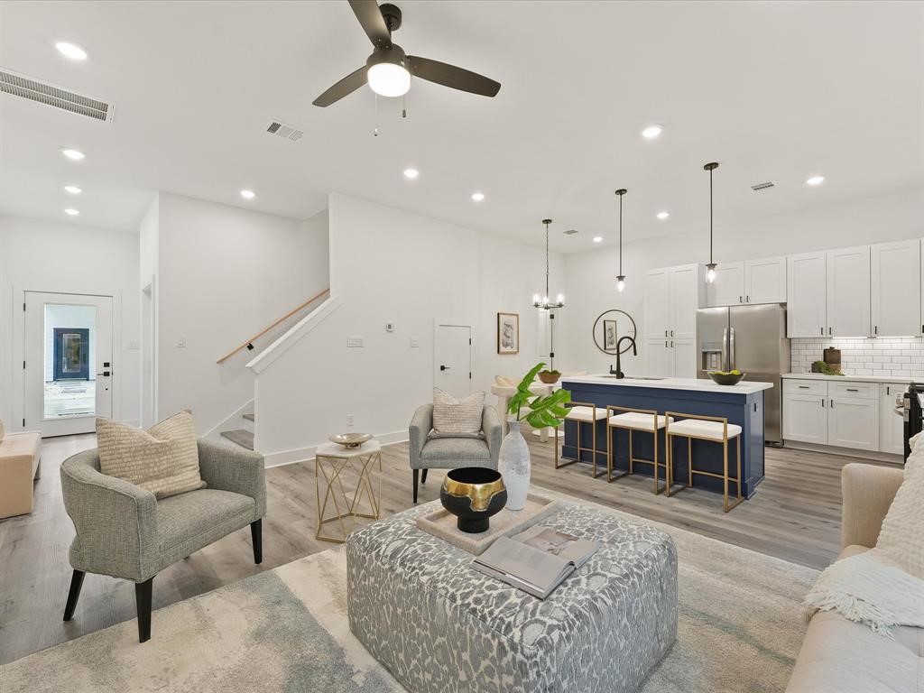 4012 Northfield Lane Houston, TX 77092 - Photo 5 of 17 a living room with furniture kitchen view and a chandelier