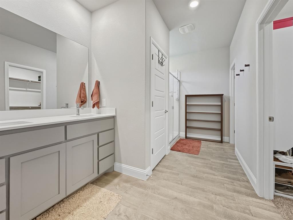 2216 Redwing Drive Denton, TX 76205 - Photo 20 of 38 a hallway with white cabinets and dresser