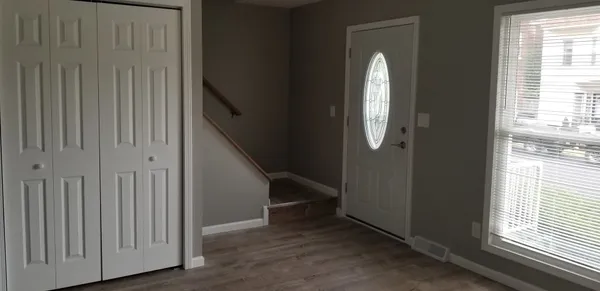 a view of a livingroom with stairs and furniture