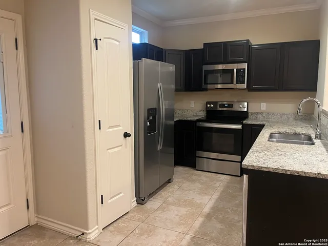 a kitchen with a refrigerator sink and microwave