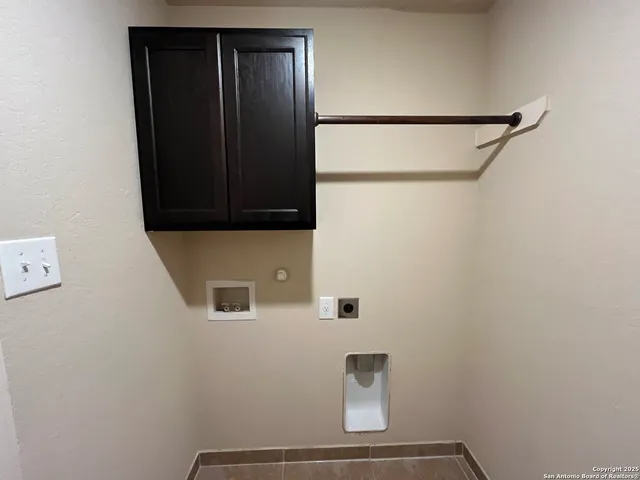 a view of an empty room with a ceiling fan and window