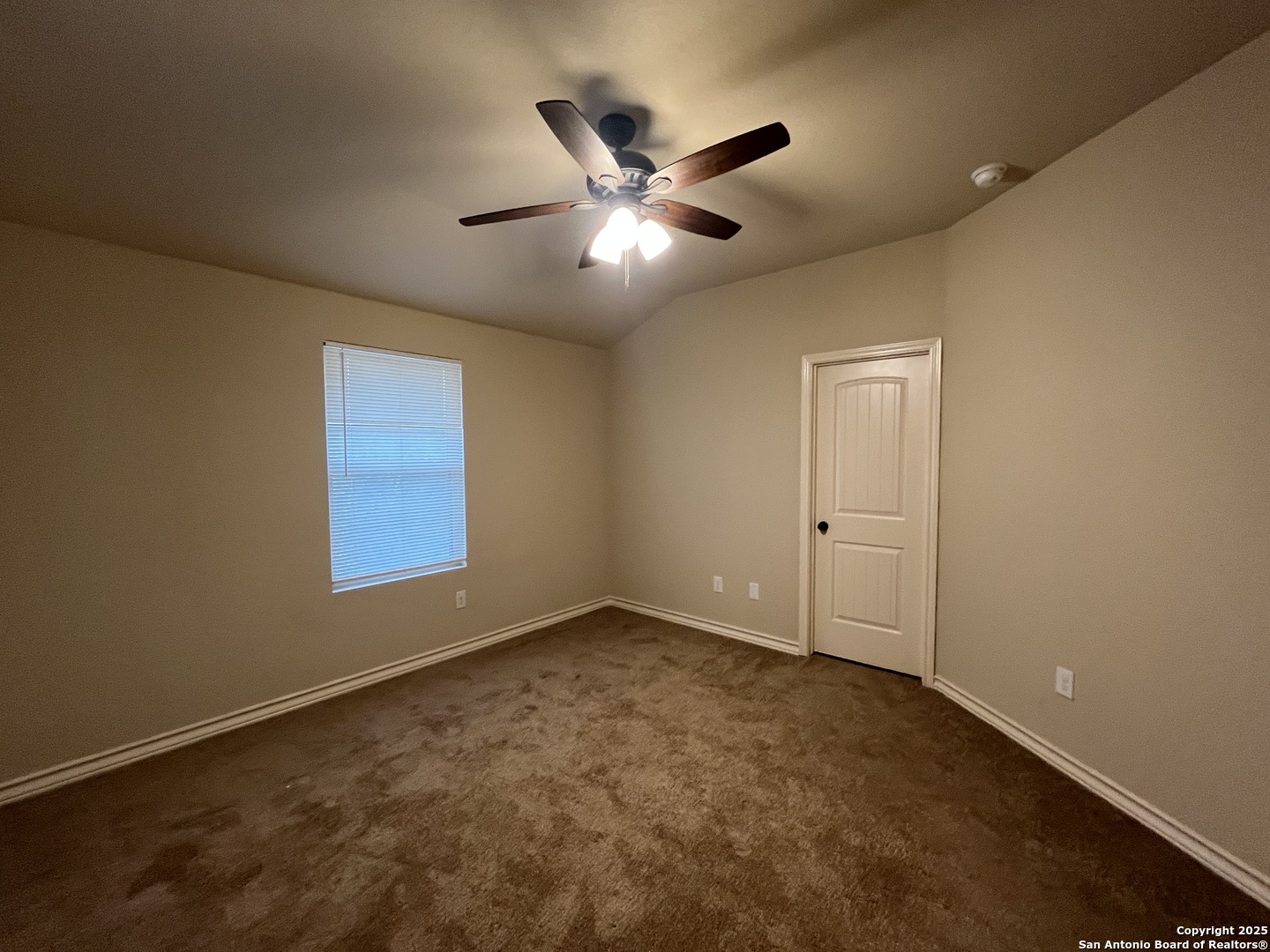 6514 Marcel Way, Unit 103 San Antonio, TX 78233 - Photo 16 of 28 a view of an empty room with a ceiling fan and window