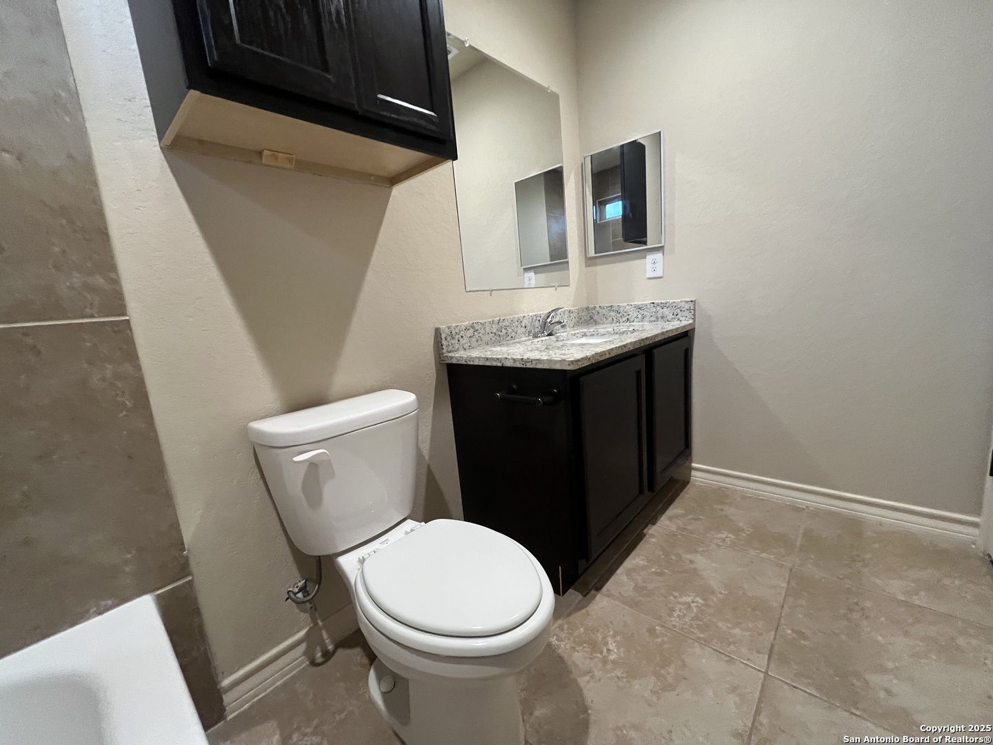 6514 Marcel Way, Unit 103 San Antonio, TX 78233 - Photo 19 of 28 a bathroom with a sink and a toilet
