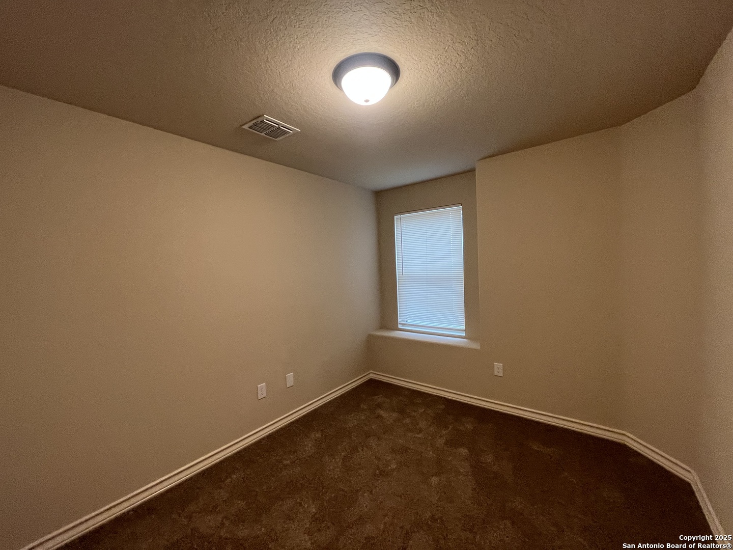 6514 Marcel Way, Unit 103 San Antonio, TX 78233 - Photo 23 of 28 an empty room with a empty space and windows