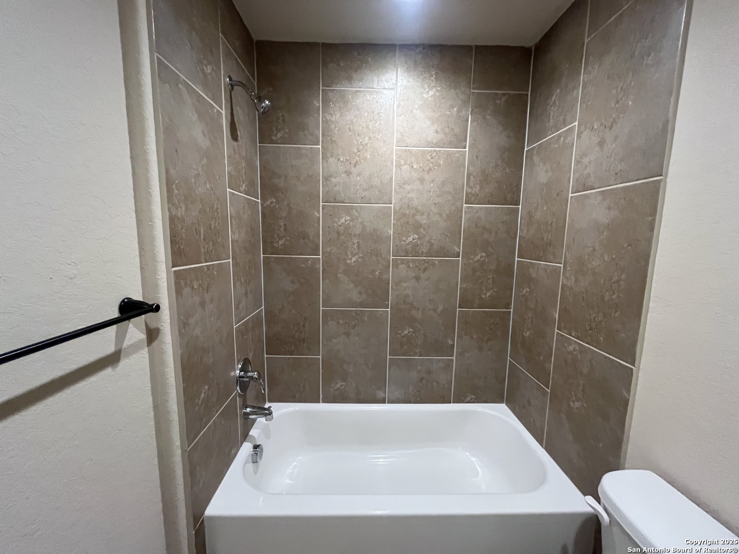 6514 Marcel Way, Unit 103 San Antonio, TX 78233 - Photo 26 of 28 a bath tub sitting next to a white toilet