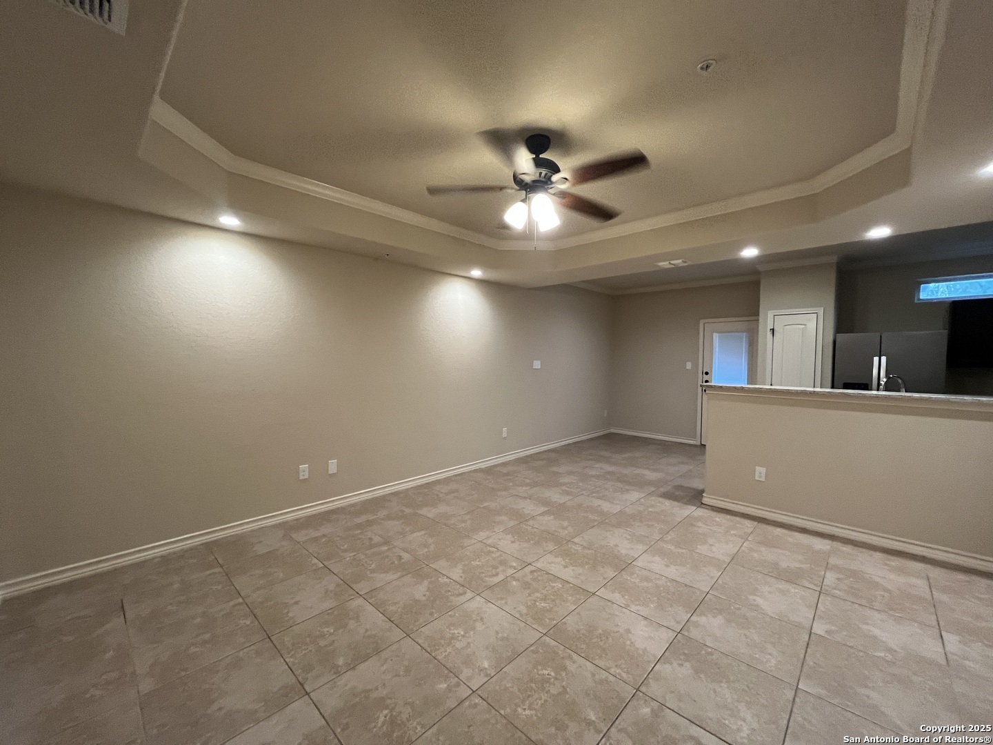 6514 Marcel Way, Unit 103 San Antonio, TX 78233 - Photo 3 of 28 a view of an empty room with a ceiling fan