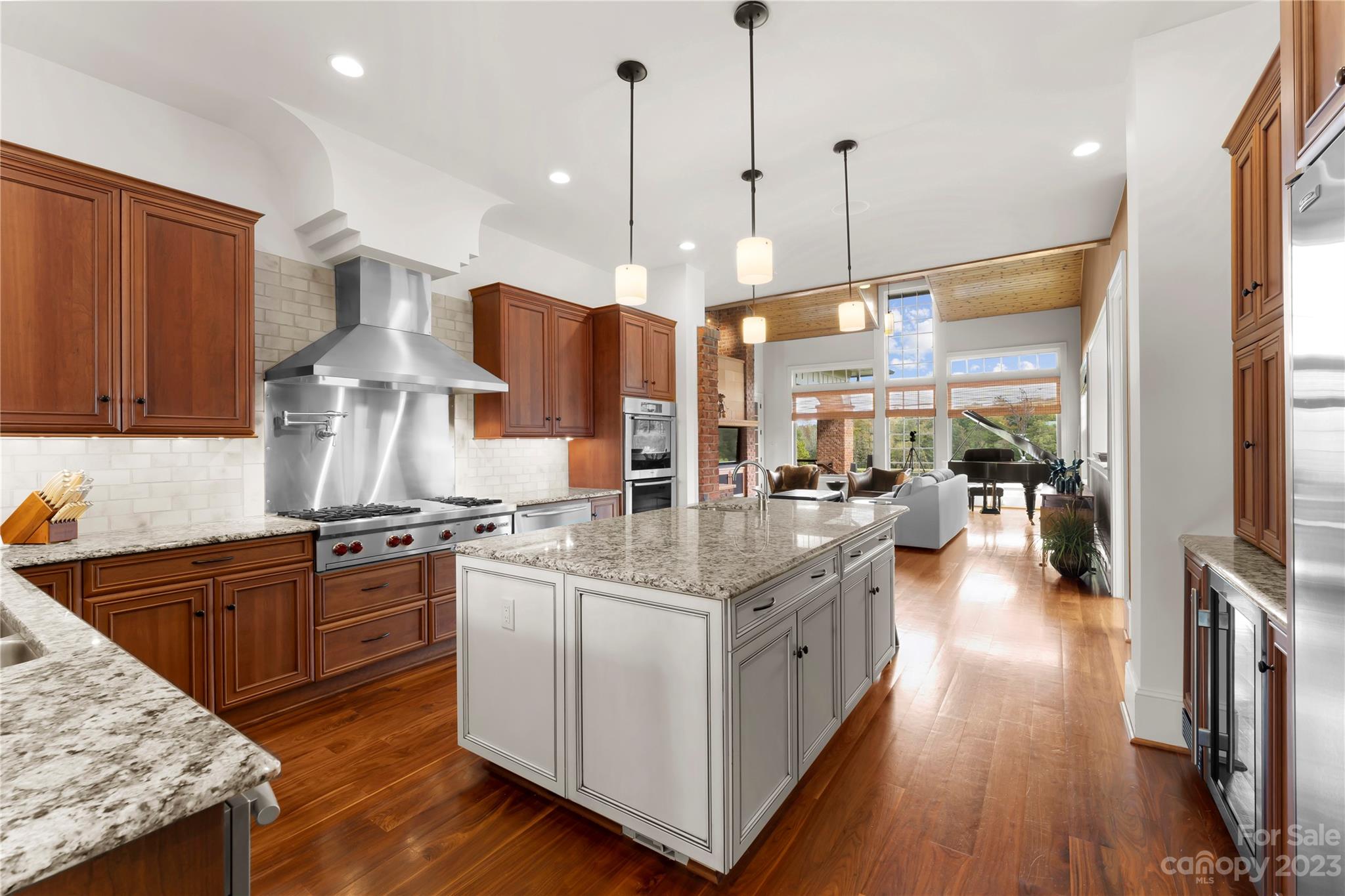 13500 Cabarrus Station Road Midland, NC 28107 - Photo 19 of 48 a kitchen with stainless steel appliances granite countertop a stove a sink dishwasher and a refrigerator with wooden floor