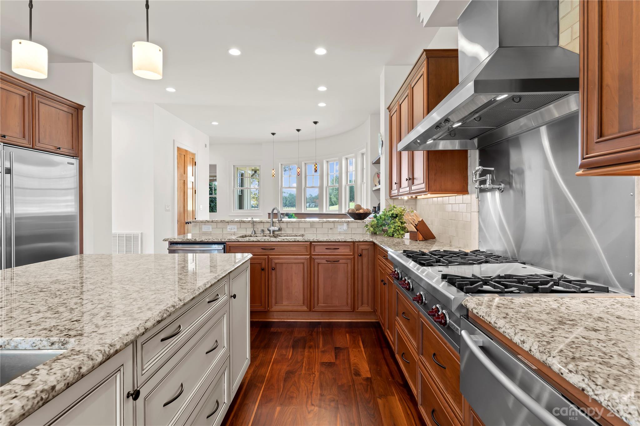 13500 Cabarrus Station Road Midland, NC 28107 - Photo 20 of 48 a kitchen with stainless steel appliances granite countertop a stove a sink dishwasher and a refrigerator