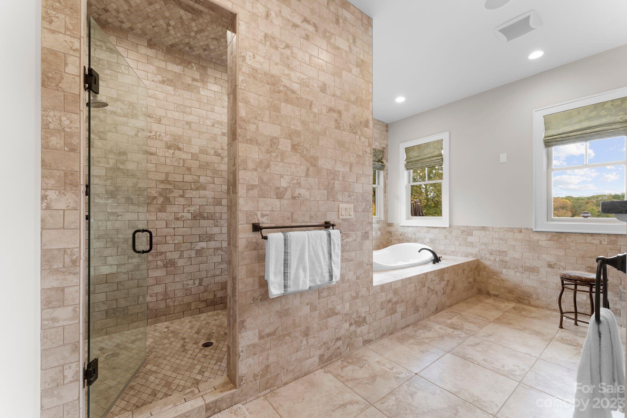 13500 Cabarrus Station Road Midland, NC 28107 - Photo 26 of 48 a spacious bathroom with a bathtub and a shower