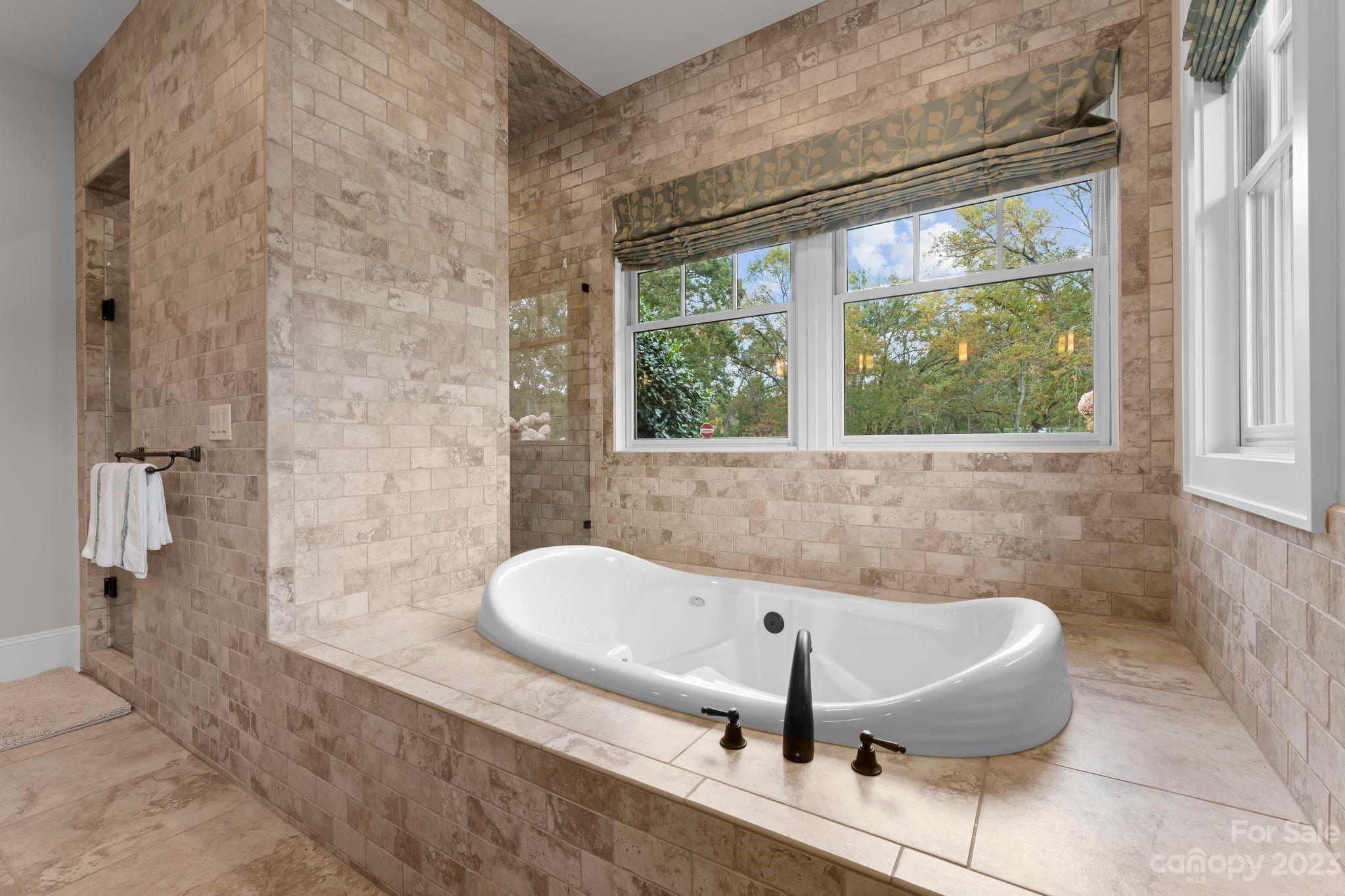 13500 Cabarrus Station Road Midland, NC 28107 - Photo 27 of 48 a bath tub sitting in a bathroom next to a window