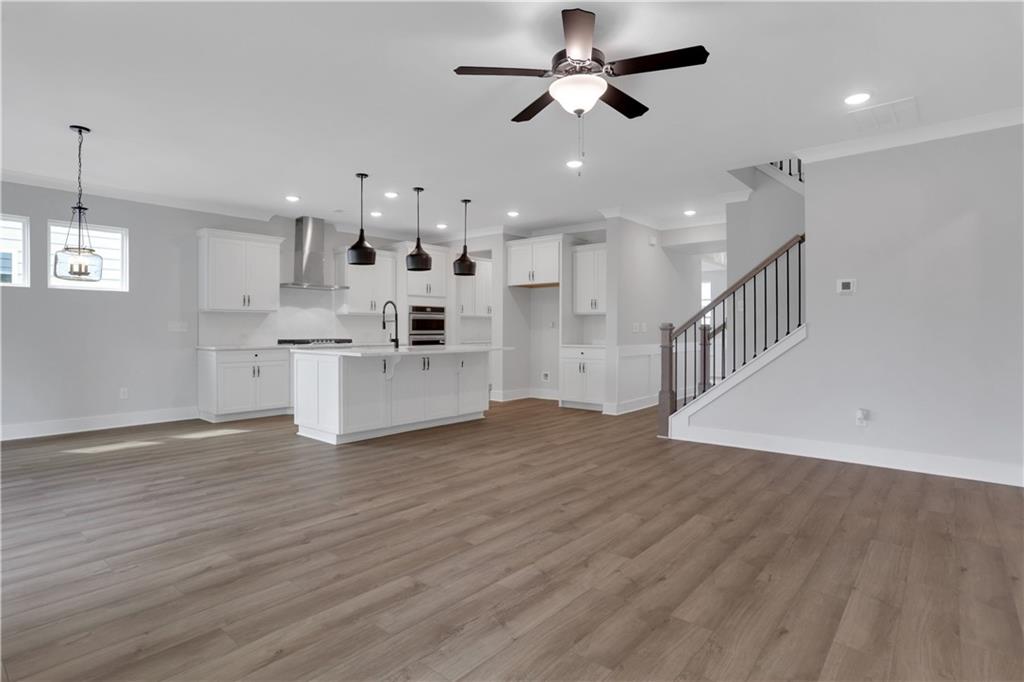 508 Pine Bough Road Ball Ground, GA 30107 - Photo 12 of 47 a view of a kitchen with a stove cabinets and wooden floor