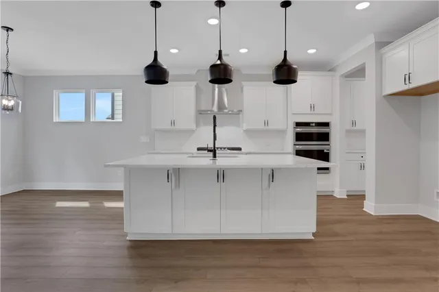 a view of a kitchen with wooden floor and electronic appliances