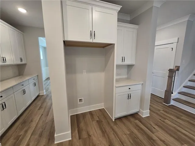 a kitchen with white cabinets and white appliances
