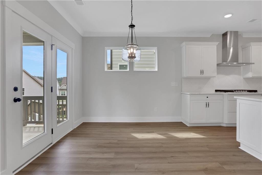 508 Pine Bough Road Ball Ground, GA 30107 - Photo 20 of 47 a view of a kitchen with wooden floor and a refrigerator
