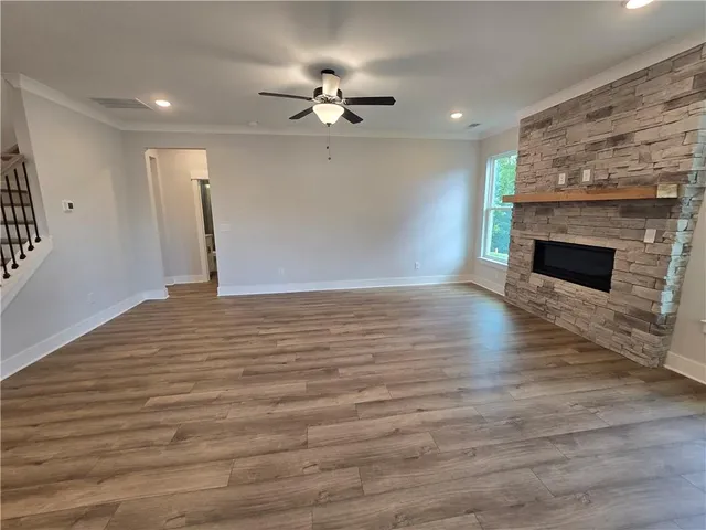 a big room with wooden floor and windows