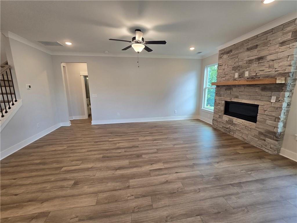 508 Pine Bough Road Ball Ground, GA 30107 - Photo 24 of 47 a view of an empty room with wooden floor fireplace and a window
