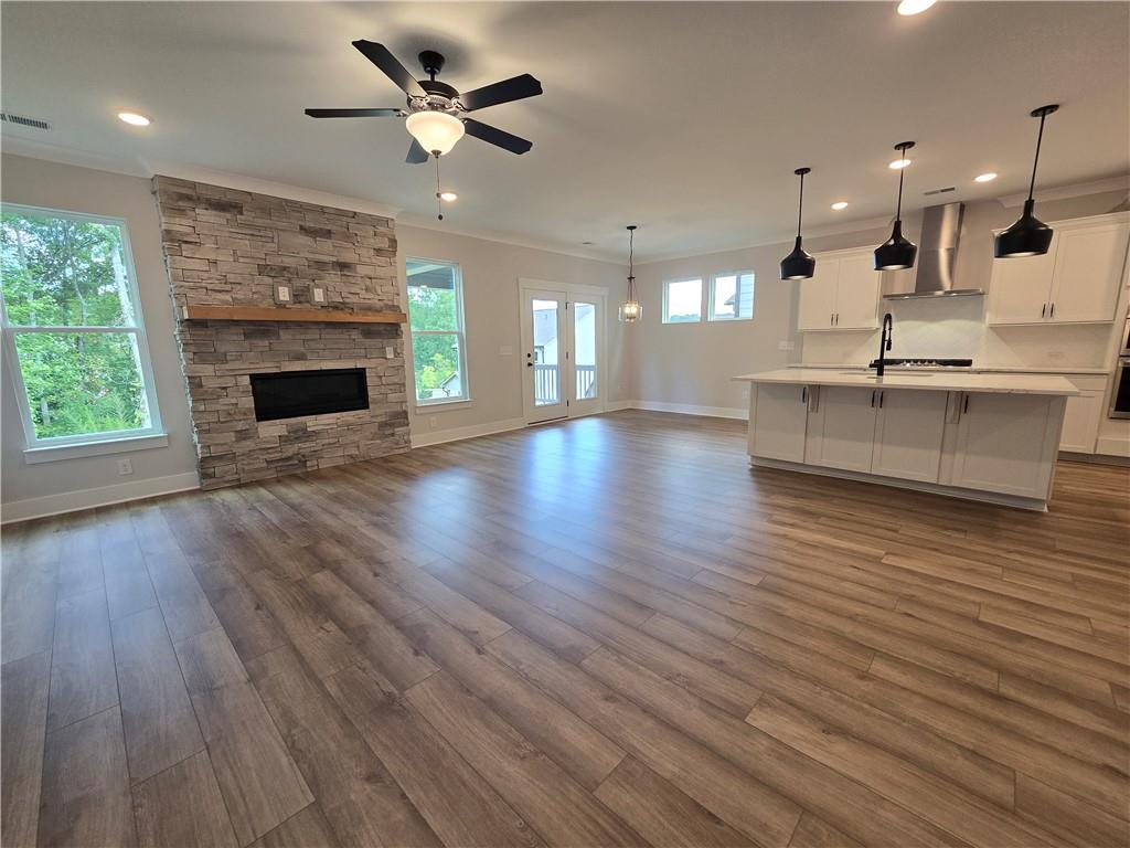 508 Pine Bough Road Ball Ground, GA 30107 - Photo 26 of 47 a view of an empty room with wooden floor and a fireplace