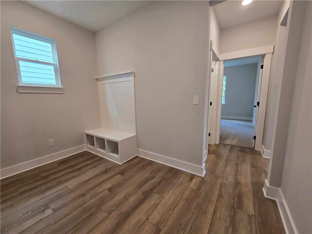 508 Pine Bough Road Ball Ground, GA 30107 - Photo 27 of 47 an empty room with wooden floor and windows