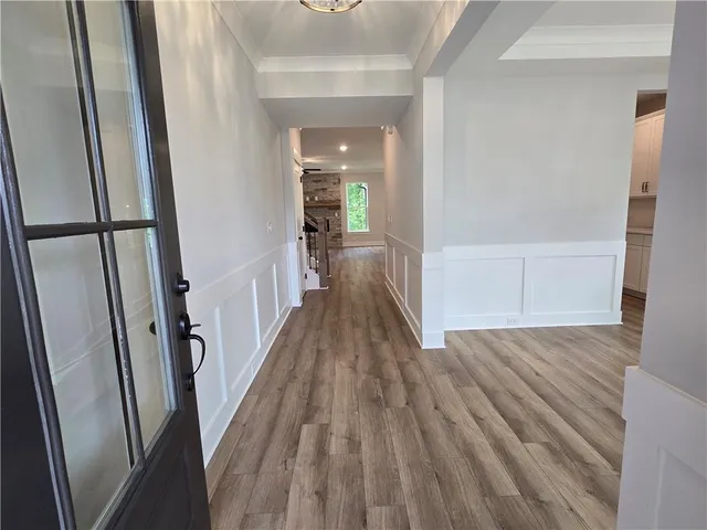 a view of a hallway with wooden floor