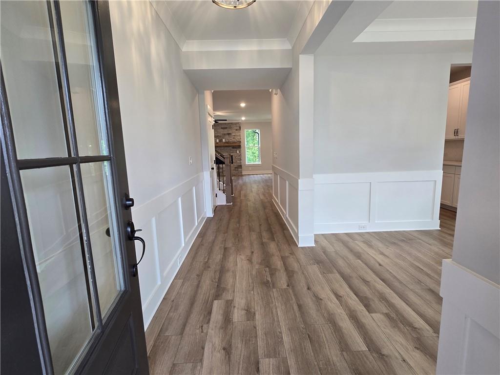 508 Pine Bough Road Ball Ground, GA 30107 - Photo 3 of 47 a view of a hallway with wooden floor and staircase