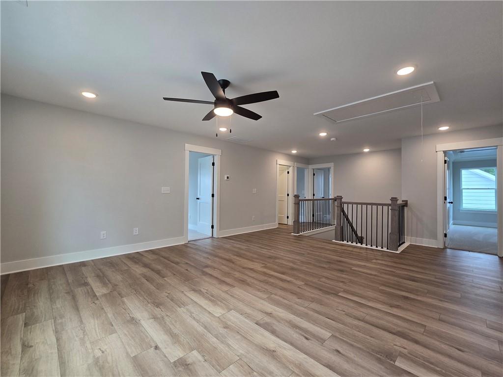 508 Pine Bough Road Ball Ground, GA 30107 - Photo 34 of 47 a view of an empty room with wooden floor and a ceiling fan