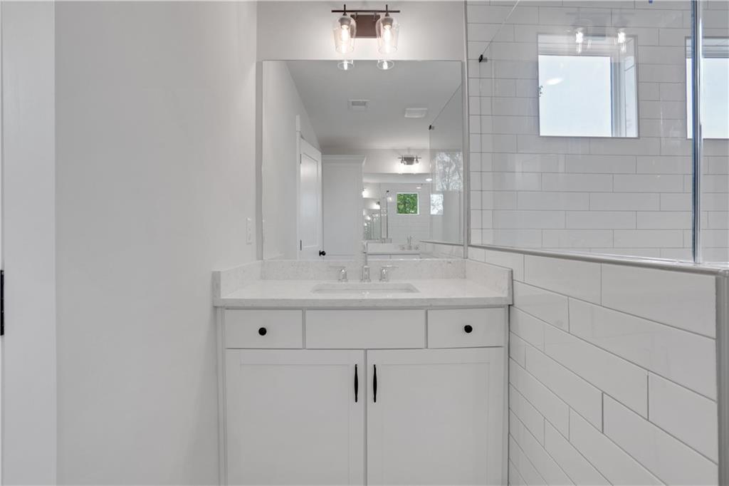 508 Pine Bough Road Ball Ground, GA 30107 - Photo 35 of 47 a bathroom with a sink and mirror