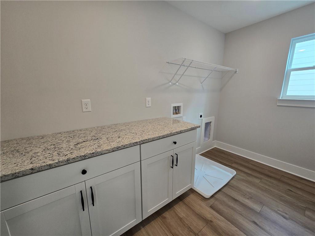 508 Pine Bough Road Ball Ground, GA 30107 - Photo 42 of 47 a room with a sink cabinets and wooden floor